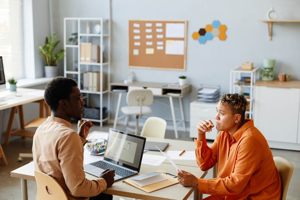 Side view portrait of two black business people working together during meeting in IT development office